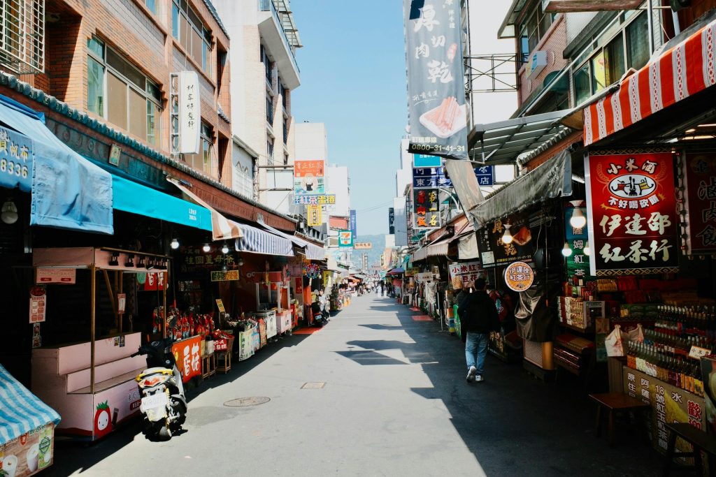 Explore a bustling street market in Keelung, Taiwan, showcasing vibrant stalls and local life.